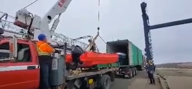 crane lifting coach boat